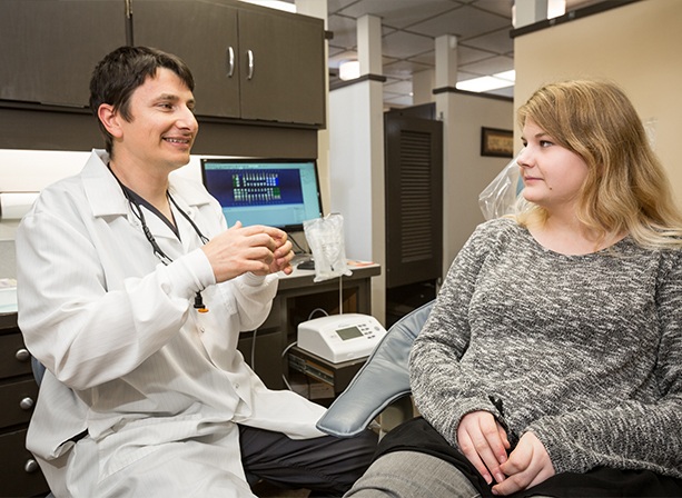 Doctor Paskalev talking to a patient about sleep apnea treatment in Eugene