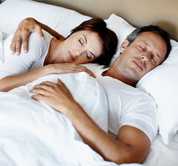 Man and woman sleeping soundly together