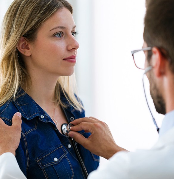 Doctor listening to a patient’s heart with stethoscope