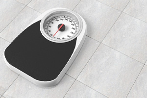 Bathroom scale on a gray tiled floor