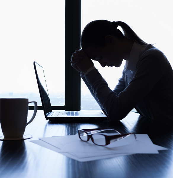 Frustrated woman in need of combined sleep apnea therapy falling asleep at desk