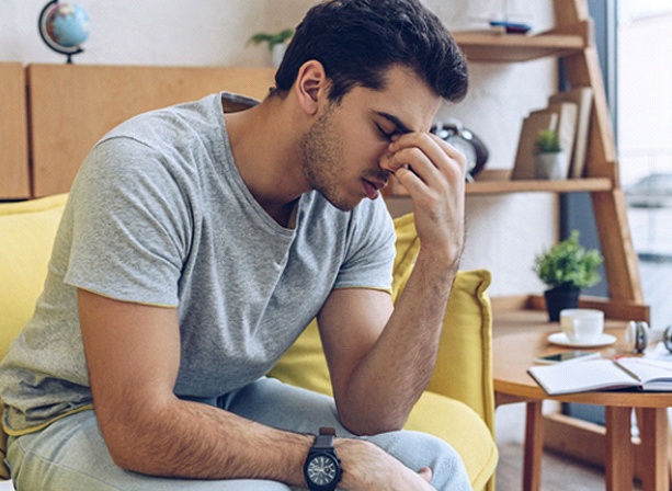 Man falling asleep on couch