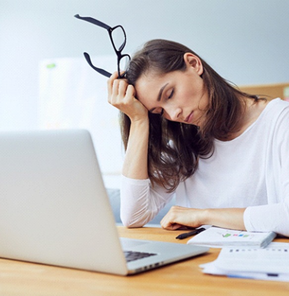 Tired woman falling asleep at desk