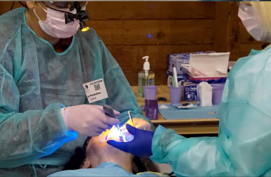 Dentist and team member treating patient