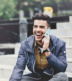 Smiling man talking on the phone