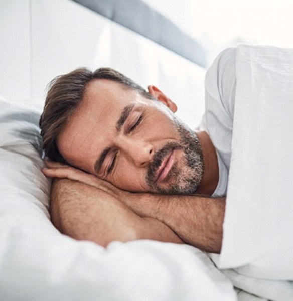 Bearded man sleeping soundly on his side