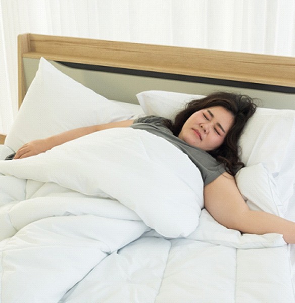 Woman tossing and turning in bed