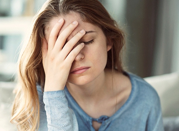 Tired woman experiencing symptoms of sleep apnea