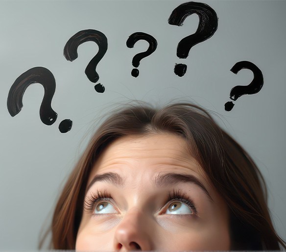 Woman with question marks around her head